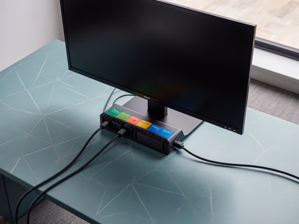 ergonomic_hot-desking_station_with_labeled_universal_docking_station_cables_neatly_routed_behind_monitor